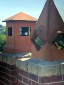 Chimney Scan Camera peeking out of Terra Cotta Clay Chimney Pots