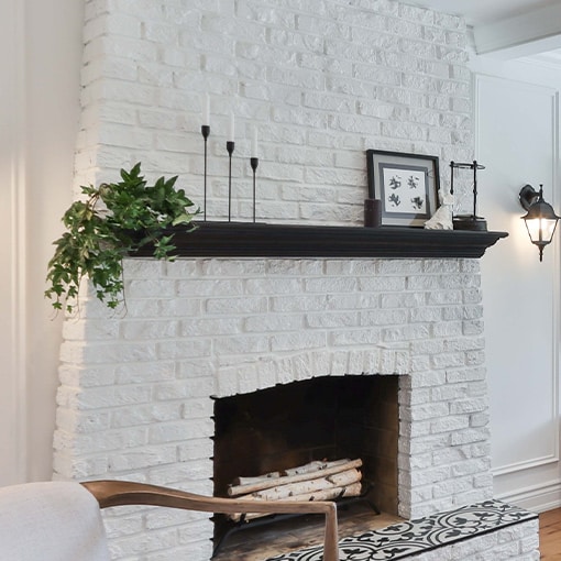 White painted brick fireplace mantel surround