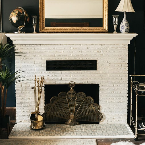 Painted White Brick Fireplace with Decorative Brass Metal Screen 