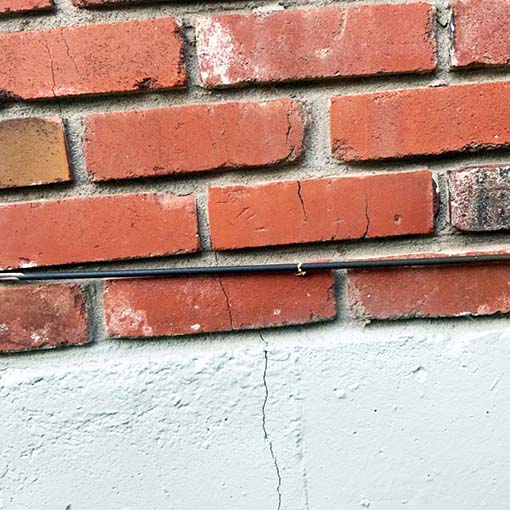 chimney bricks cracking into a homes chimney and foundation