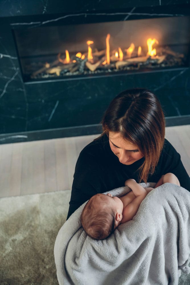 https://fullservicechimney.com/wp-content/uploads/2023/04/mother-with-baby-near-beautiful-fireplace.jpg