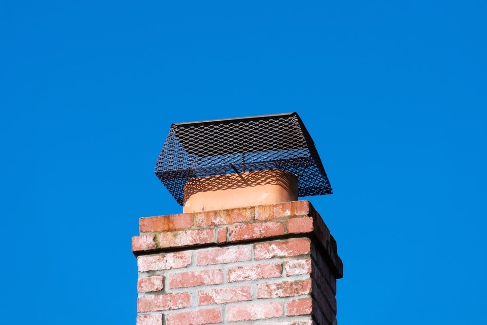 Chimney cap installed to prevent rodent entry to home Chimney cap installed to prevent rodent entry to home