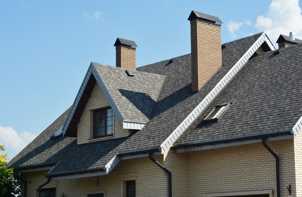 House asphalt shingles rooftop with chimney
