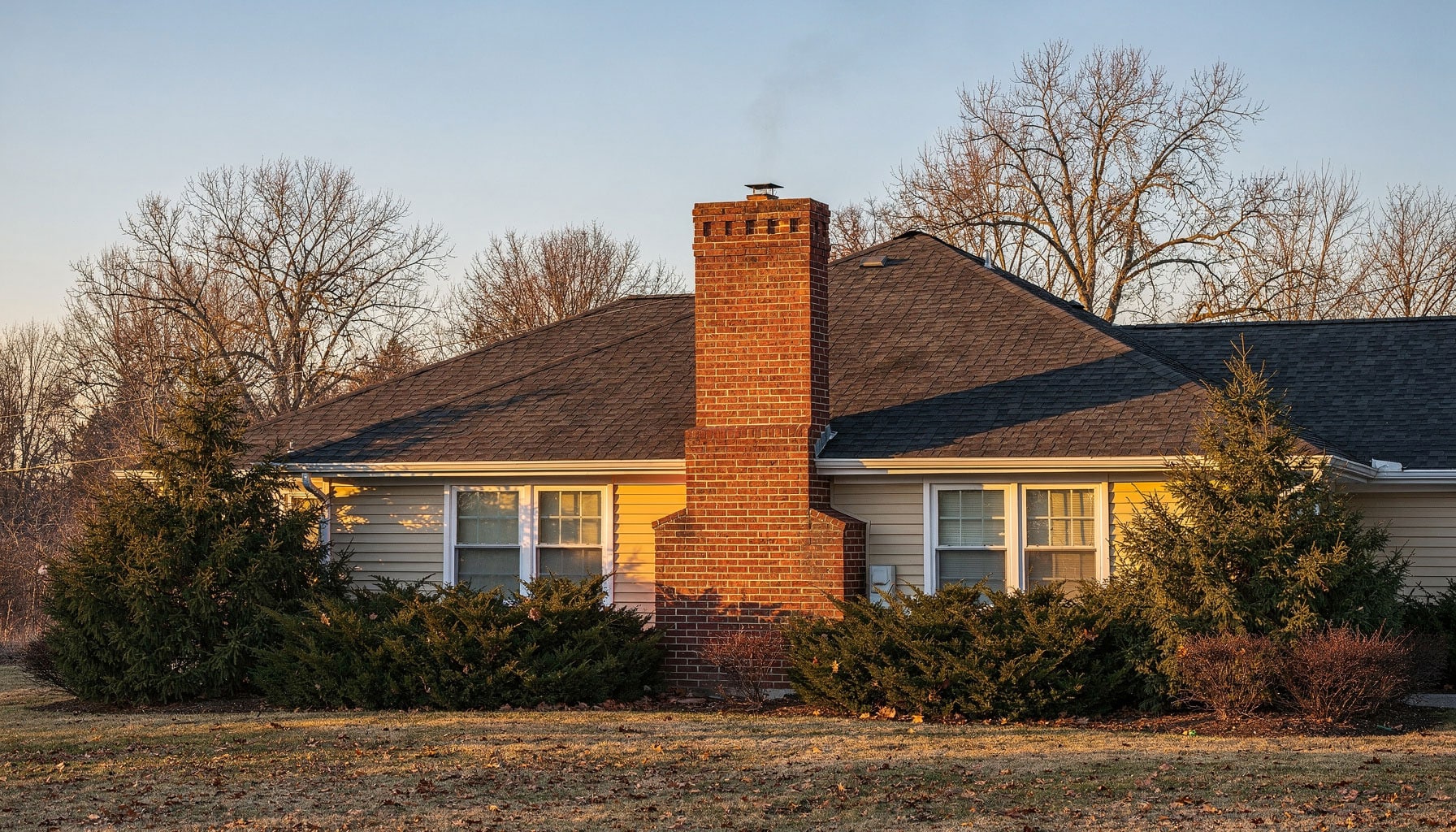 house with a brick chimney during a mild Winter